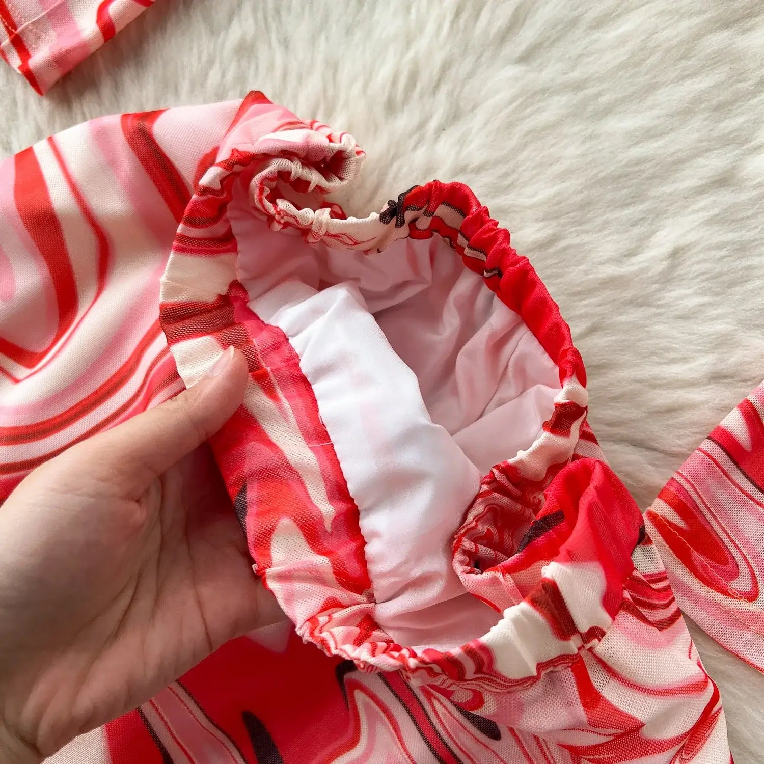 Two piece mesh skirt set marble print featuring red and white striped swimwear with a ruched elastic waistband closure type.