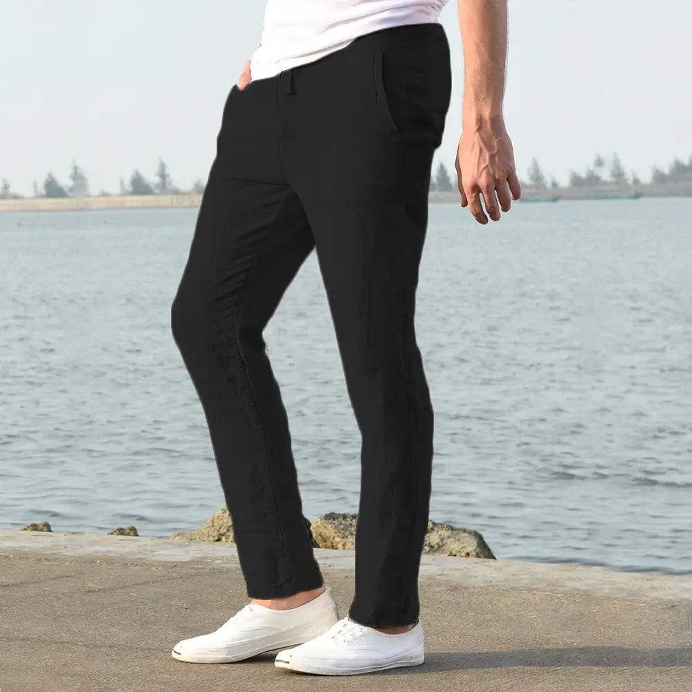 Black slim-fit men cotton linen trousers made of smooth lightweight fabric for breathable casual wear.