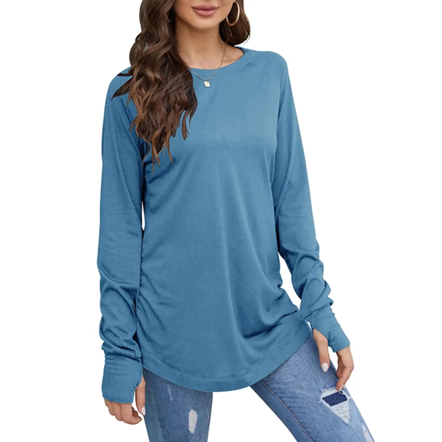 women long sleeve cotton tunic top in soft blue with a relaxed fit and subtle ruching pattern along the sides featuring long sleeve length.