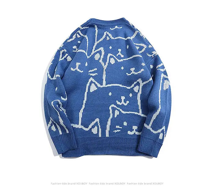 Pull ample en maille bleue, avec un motif ludique de chat de dessin blanc dans un style Harajuku.