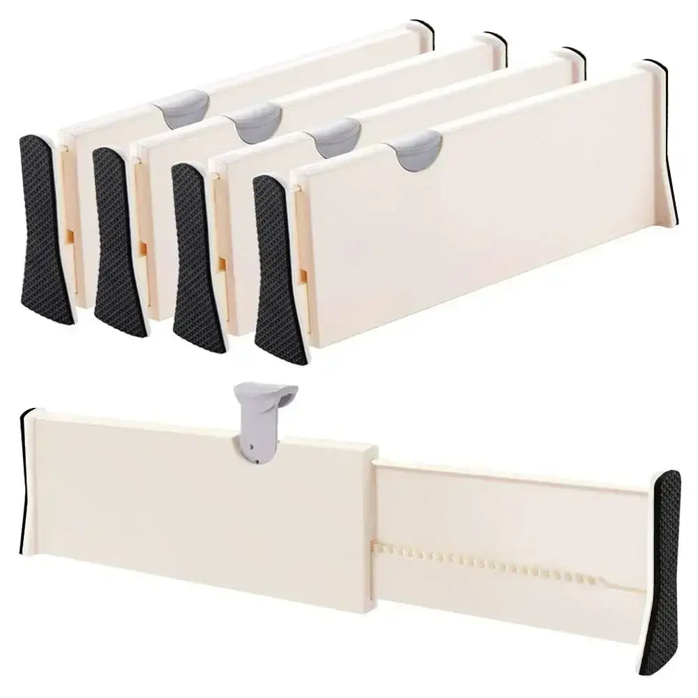 Cream-colored plastic adjustable drawer dividers with black textured grips and gray sliding tabs for white storage partition organization.