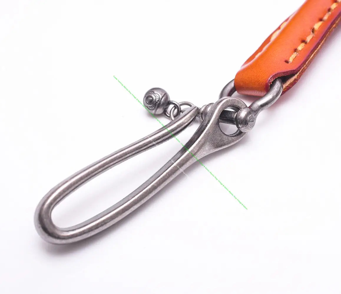 Leather biker wallet chain punk jeans accessory featuring an orange leather strap with tan stitching attached to a silver-toned metal key ring with an oval loop and small spherical charm.