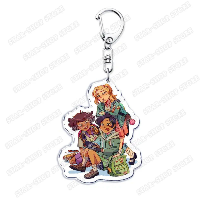 Clear acrylic Amphibia anime keychain featuring three illustrated characters in scout uniforms with a silver metal clasp.