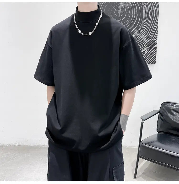Black oversized turtleneck t-shirt with short sleeves designed for casual streetwear in a comfortable cotton material.