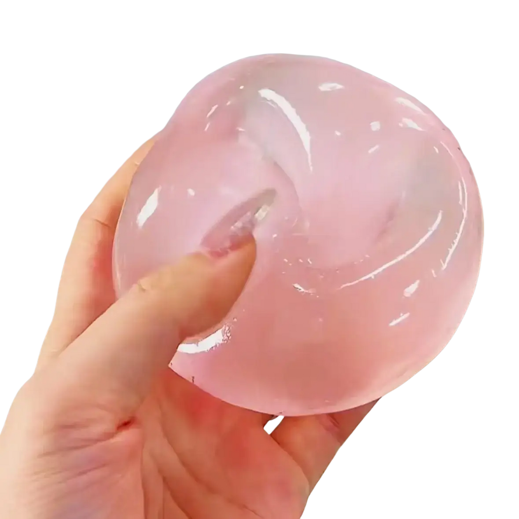 A translucent pink gel ball stress ball with a smooth glossy surface in the blue coconut oil stress ball squeeze toy line