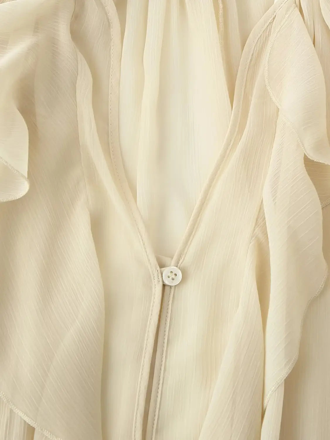 A delicate off-white long sleeve ruffle shirt long chiffon blouse featuring soft ruffled layers and a subtle textured weave.