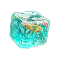 A translucent turquoise swim ocean maltose squishy cube filled with colorful seashells starfish and glittery stars viewed from front