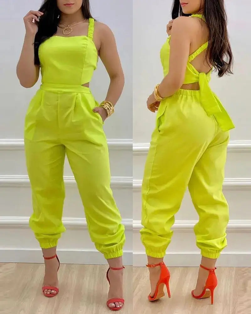 Bright neon yellow women summer printed jumpsuit featuring a halter neckline, side cutouts, and elastic cuffs.