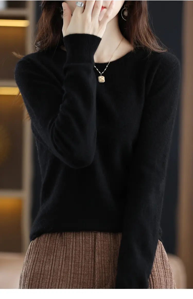 Black pure wool cashmere o-neck pullover sweater with a soft smooth texture and long sleeves.