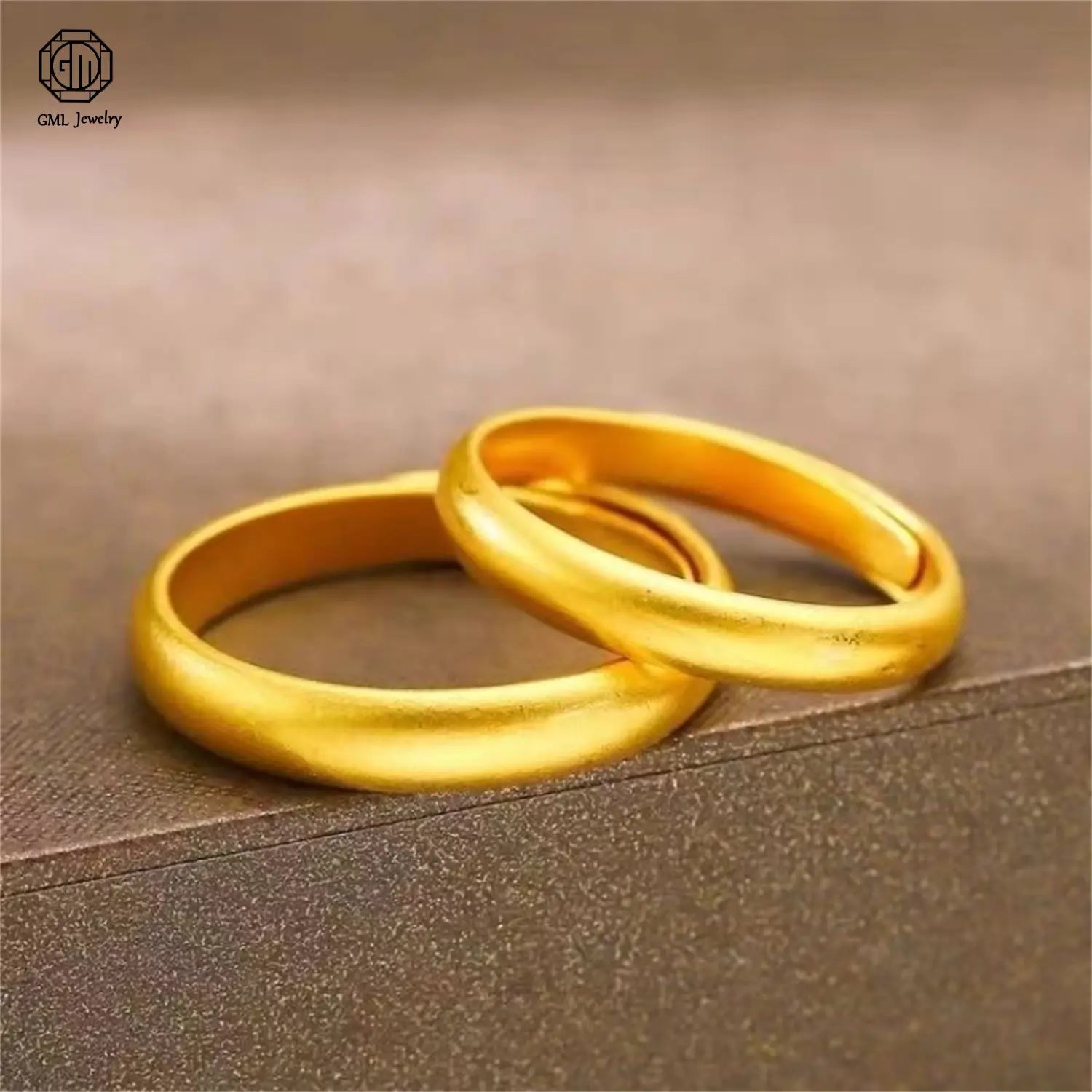 Two elegant solid gold wedding bands with a smooth polished finish and slightly rounded edges in a fade resistant sand gold adjustable gold adjustable ring matte wide band unisex design.