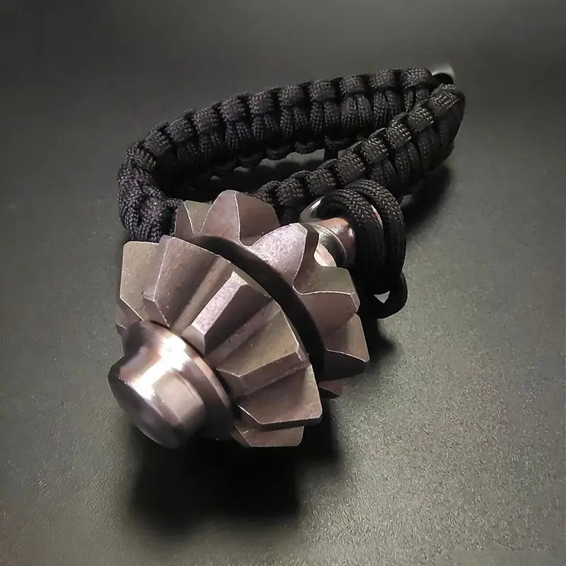 Black paracord bracelet featuring a metallic gear-shaped fob designed as a gear fidget spinner keychain emergency survival tool.
