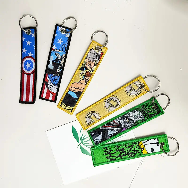 Colorful embroidered superhero keychains featuring Marvel and DC designs in a superhero embroidered keychain set anime key lanyard.