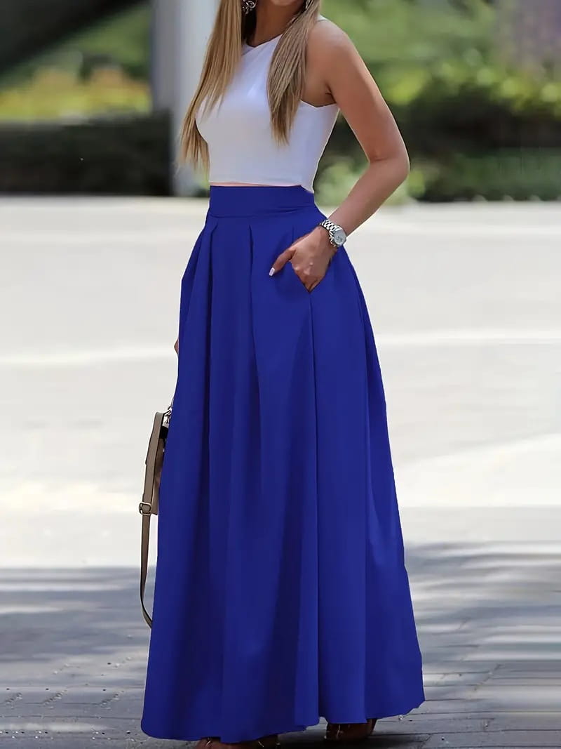 A flowing royal blue pleated high waist maxi skirt made from lightweight fabric perfect for elegant occasions.