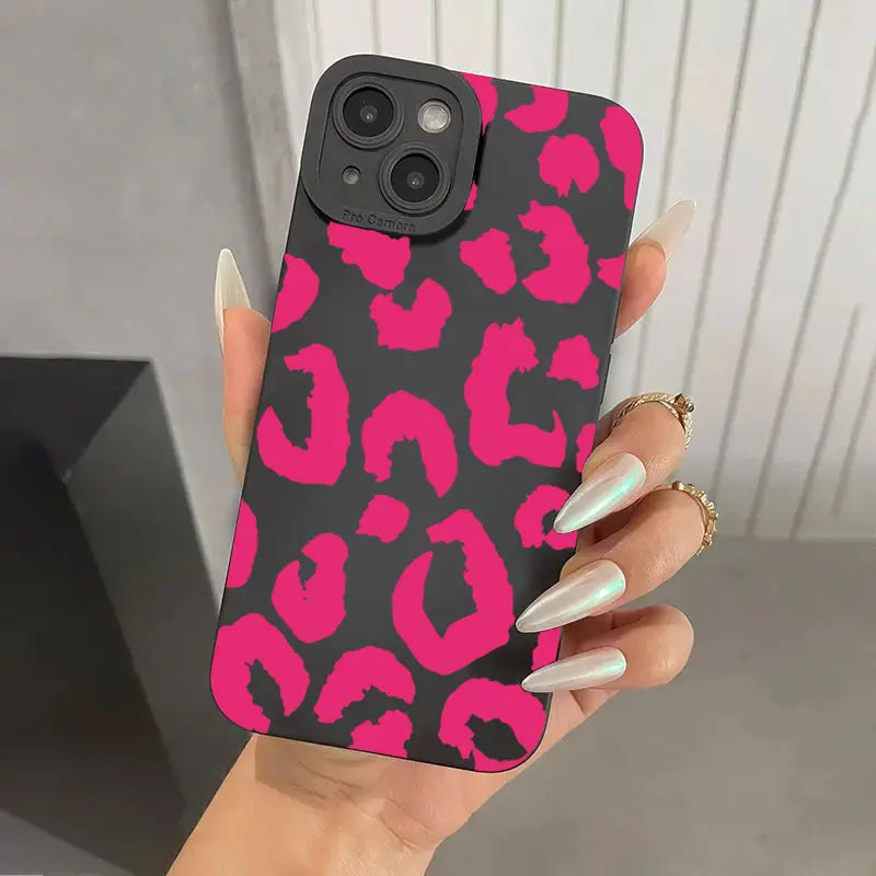 A vibrant pink and black leopard print matte black camera protective iphone case shown from the back.