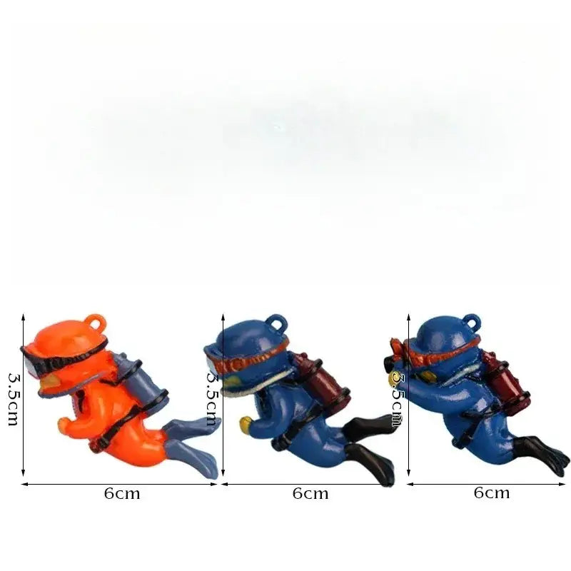 Three miniature scuba diver figurines approximately 6cm long and 5.5cm tall with detailed orange and blue gear featuring black accents and hanging loops, popular aquarium decorations for fish tanks landscape decor accessories gifts for aquatic pets.