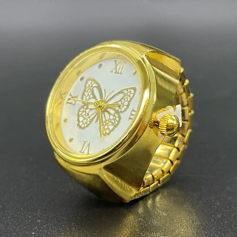 Gold-colored butterfly-themed stainless steel ring watch with a white face, roman numerals, and an ornate metal design.