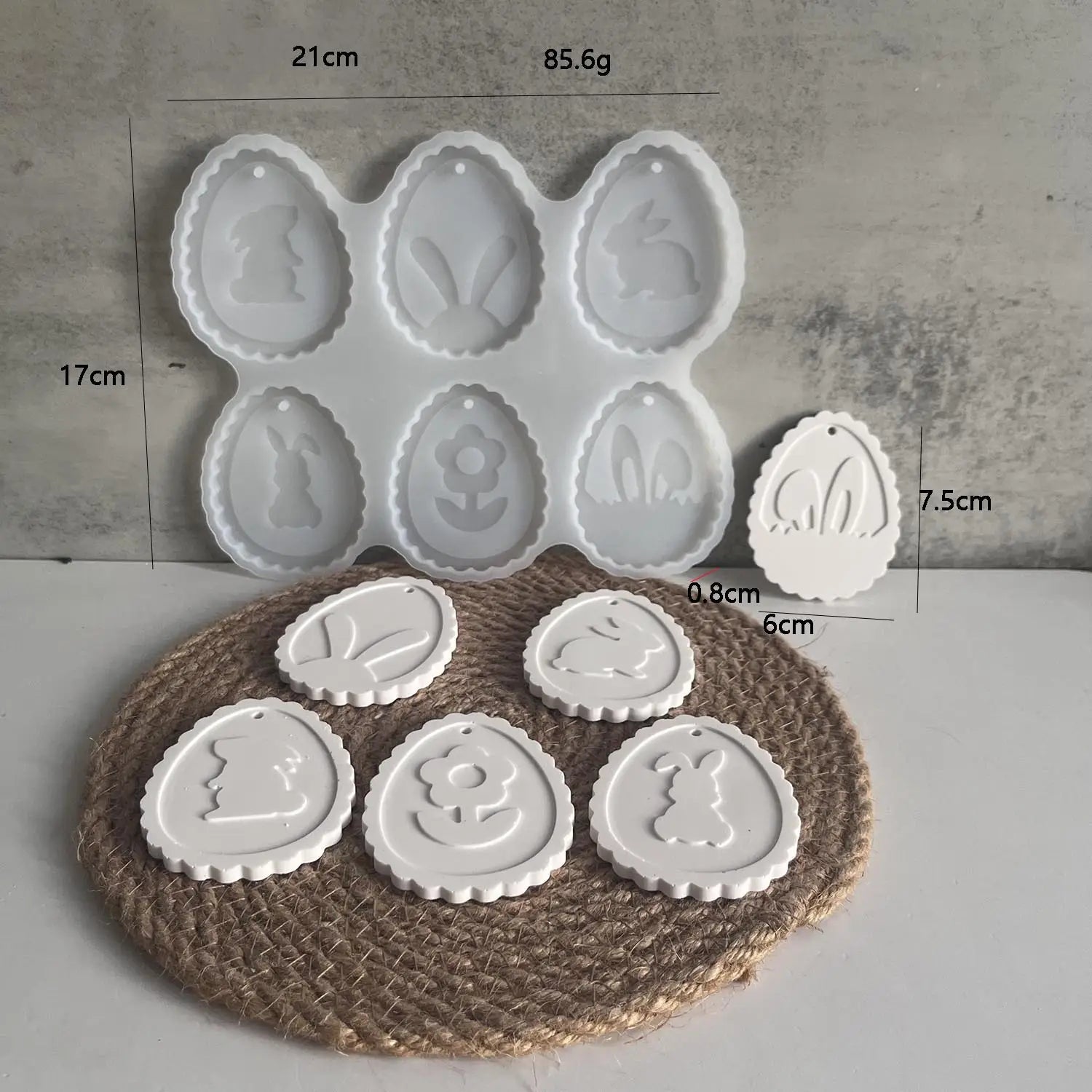 white silicone easter bunny resin pendant mold featuring easter egg shapes with bunny and flower designs and a scalloped edge
