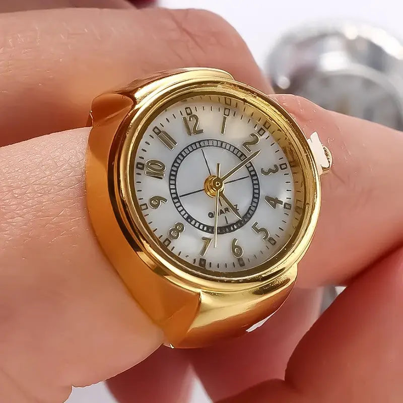 gold-toned ring watch with a white dial featuring black arabic numerals and hands and a small inner circle marked quartz designed as unisex finger jewelry gift