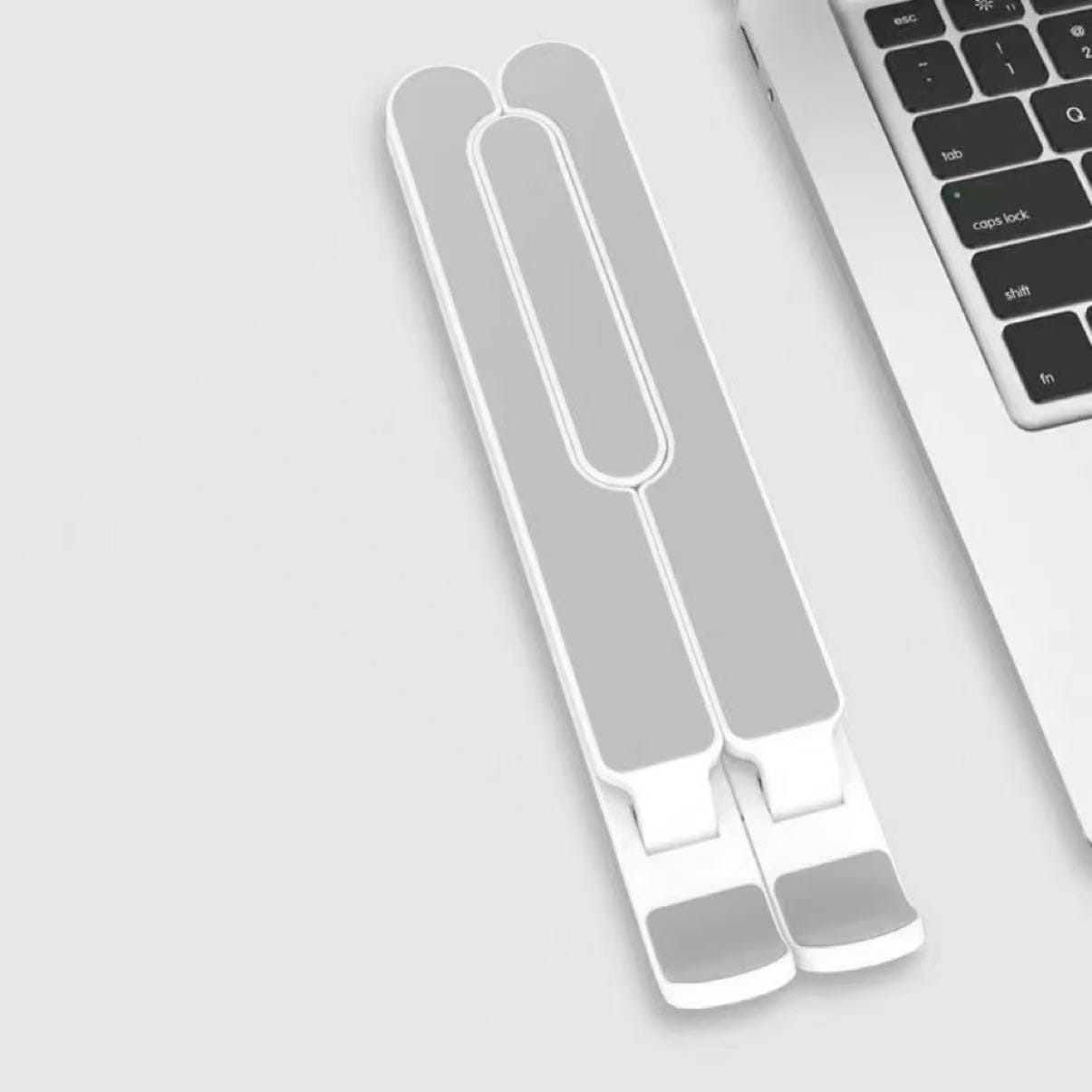 adjustable foldable white and gray laptop stand with a sleek minimalist design for ergonomic workspace setup