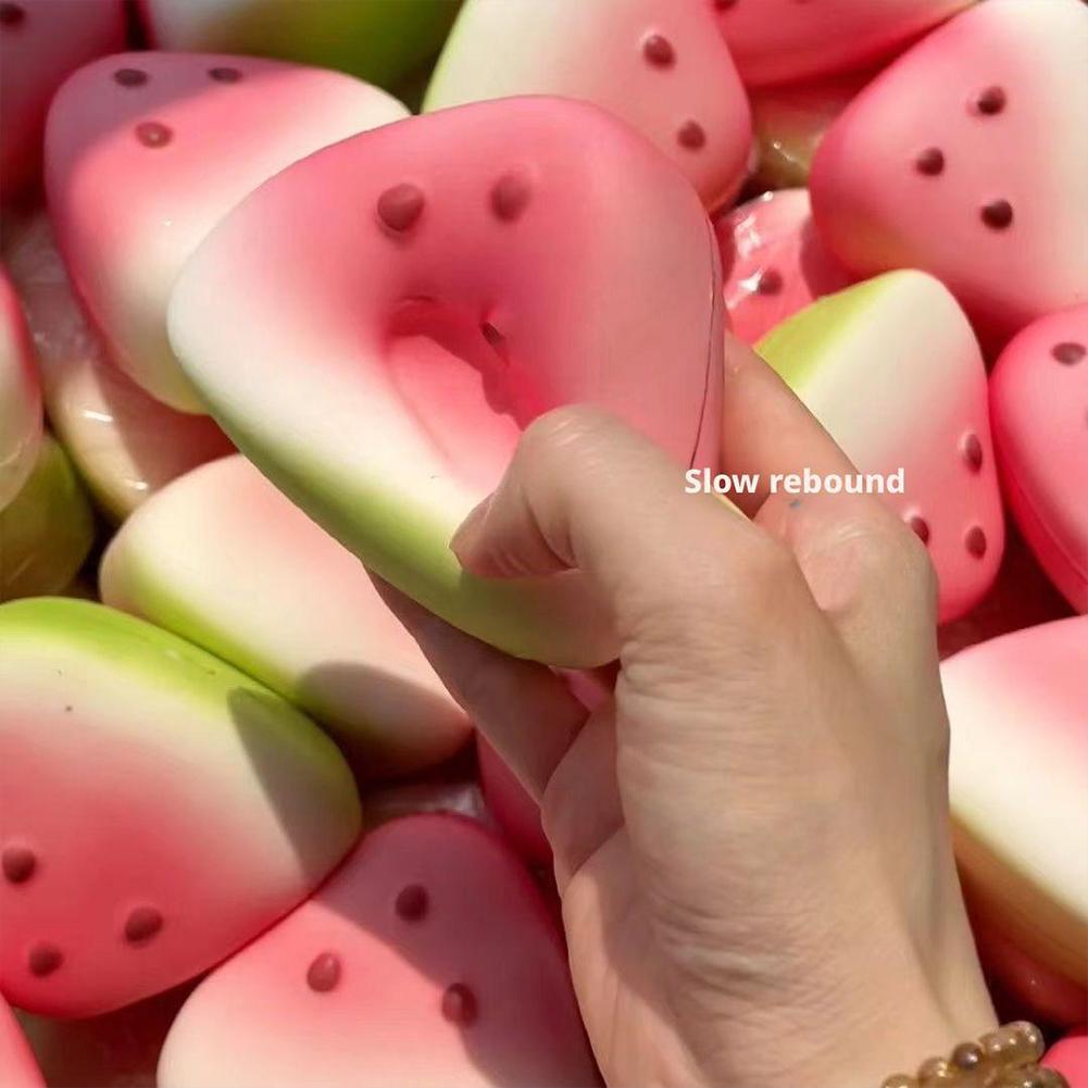 Rosa-grüner, wassermelonenförmiger Soft-Squeeze-Gegenstand zur langsamen Steigerung als taktiler Stressabbau mit schwarzen Samendetails, zur Stresslinderung.