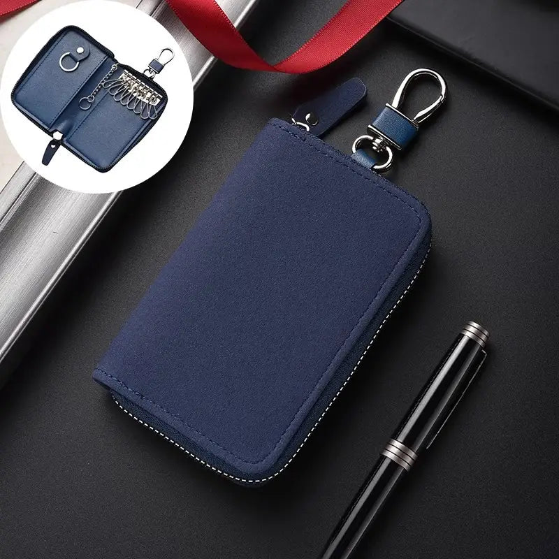 Navy blue leather key holder organizer pouch with silver-toned zipper and metal carabiner clip for convenient key storage and transport.