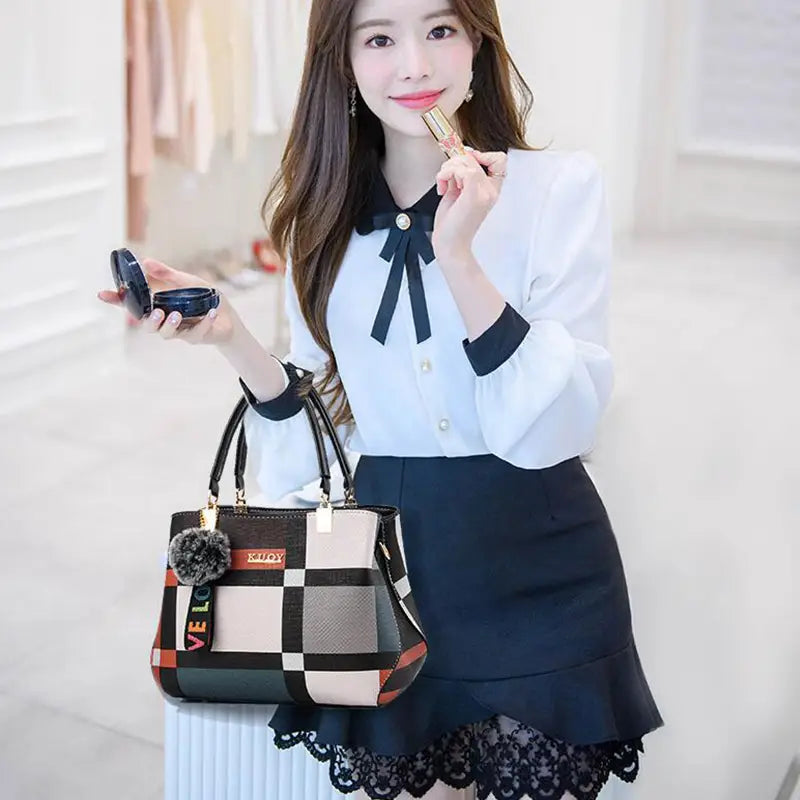 a stylish black crossbody handbag pu leather satchel in style1 style2 style1 featuring a beige and orange checkered pattern with gold-tone hardware and a fluffy gray pom-pom charm