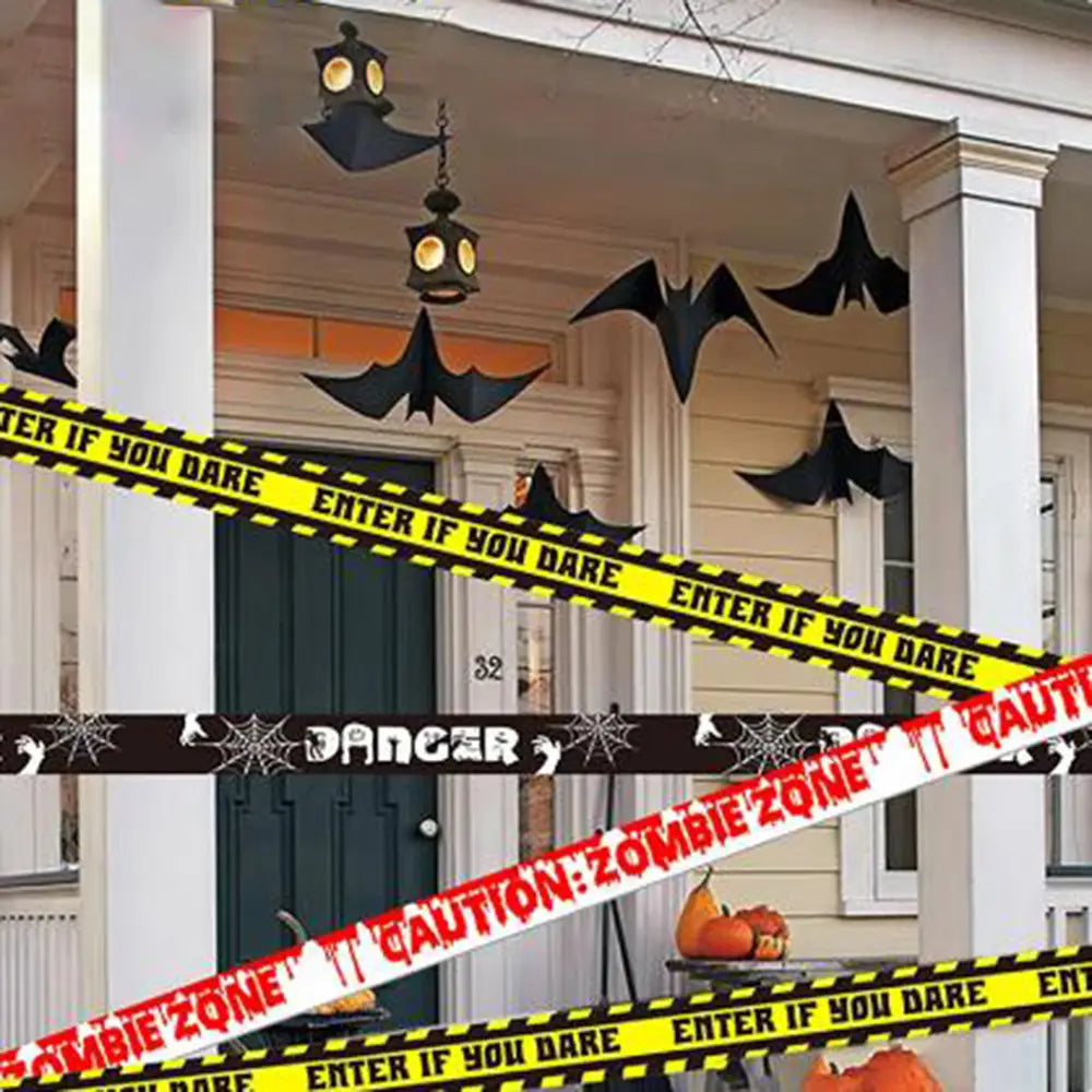 black bat-shaped halloween decorations hanging from the porch ceiling complement halloween caution tape used as a spooky party warning barrier