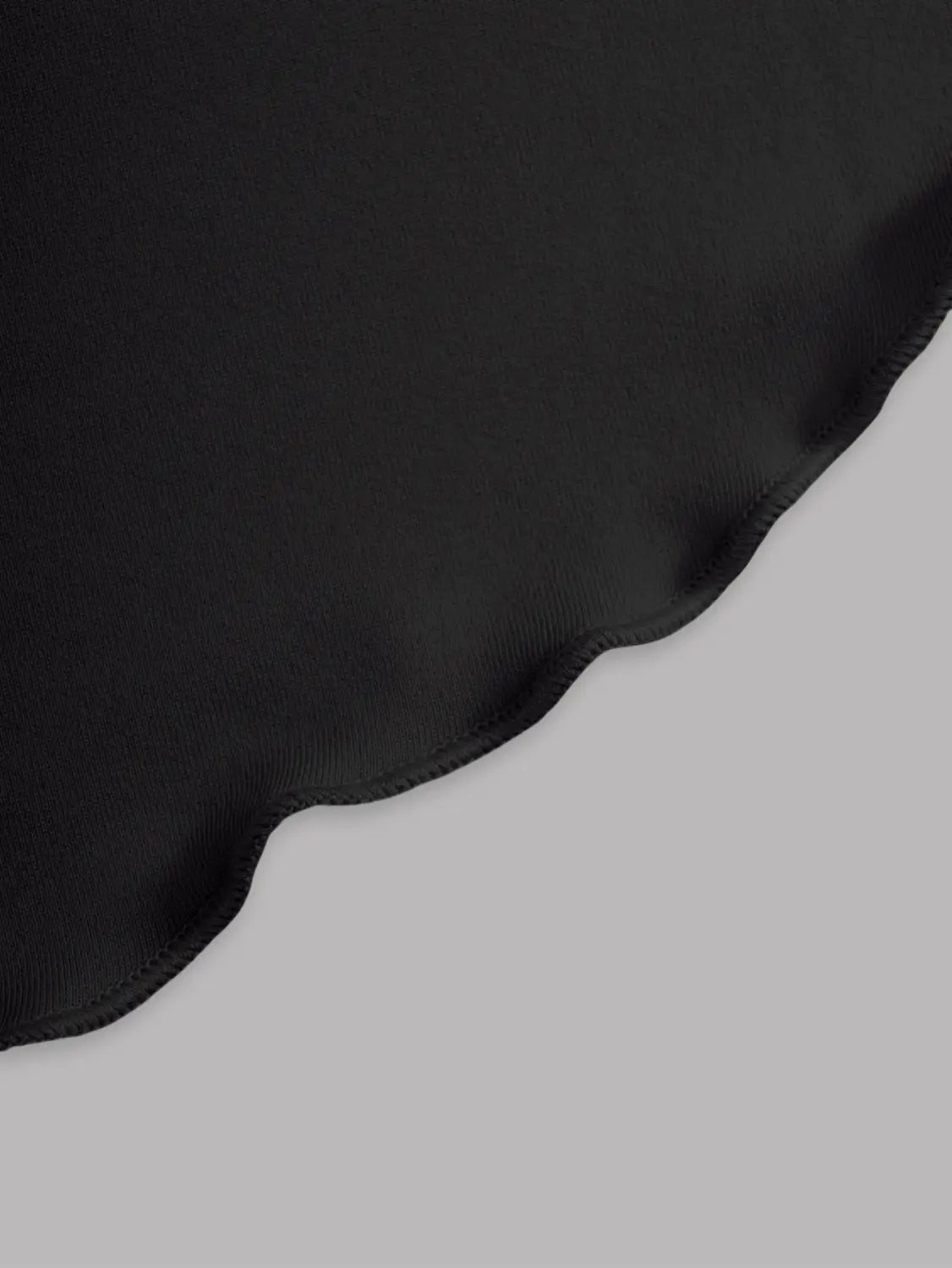 Black high waist ruffle mini skirt made of black satin fabric with a scalloped edge.