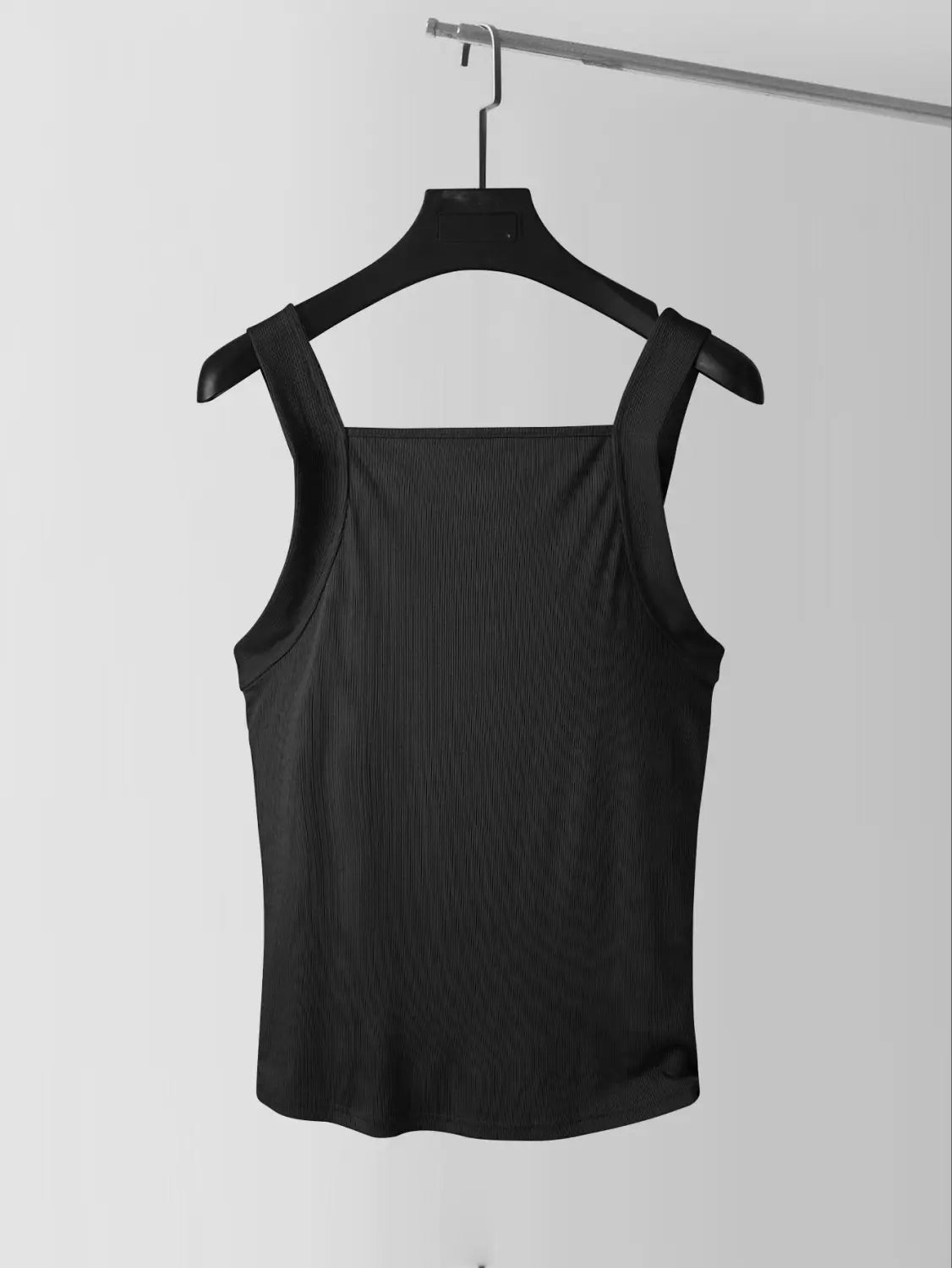 black ribbed men’s tank top with thin straps and square neck hanging on a black hanger