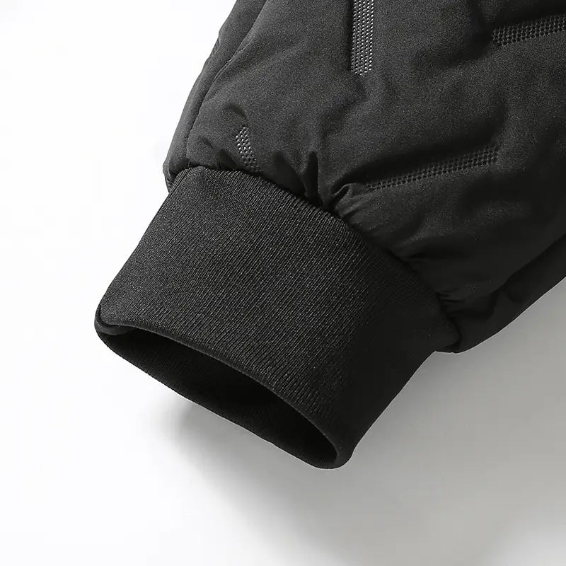 black quilted jacket sleeve with ribbed knit cuff and subtle mesh detailing paired with men fleece lined thermal sweatpants designed for waterproof winter use