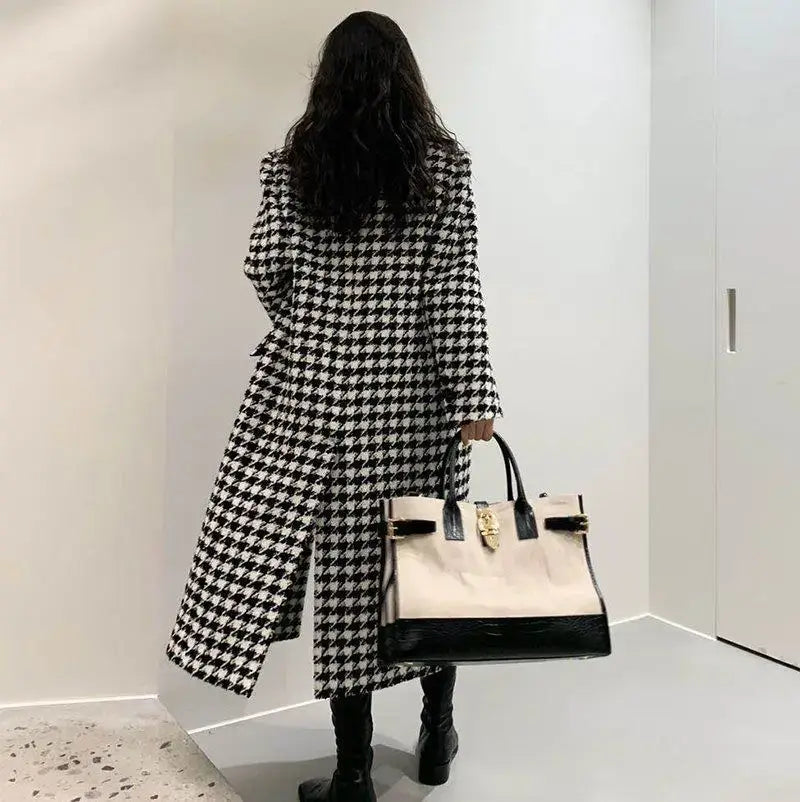 Beige and black handbag with gold-tone hardware displayed alongside a houndstooth wool double breasted coat.