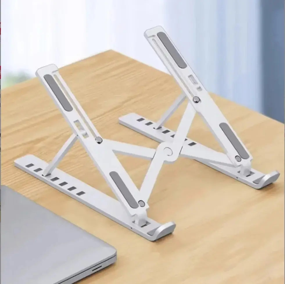 Tragbarer, faltbarer Laptopständer in Weiß mit einstellbarer Ausführung, grauen gummierten Griffpads und einem minimalistischen Design für die Verwendung als verstellbarer Halter für das Bauchpolster.