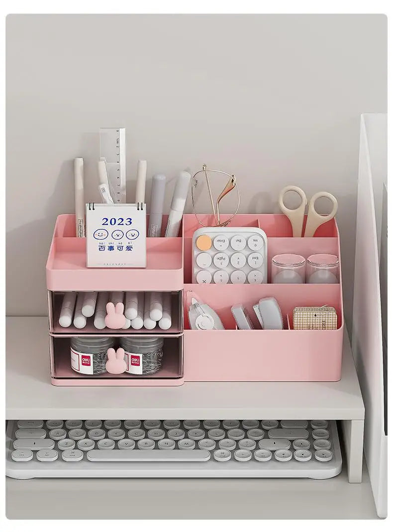 Pink plastic large capacity storage box with multiple compartments and bunny handle in modern minimalist style holding pens scissors a calculator and small jars.