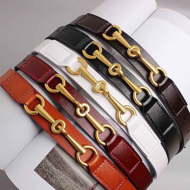 five women leather belts in brown black white red and orange with gold horsebit buckle hardware displayed together
