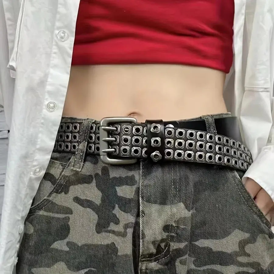 Black studded leather punk belt featuring multiple rows of square metal studs and a silver toned buckle.