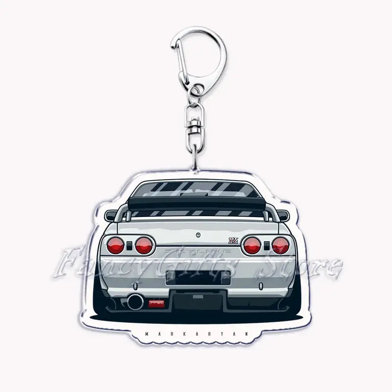 Silver acrylic Nissan Skyline R32 car keychain showing the back side with stylized rear view featuring red taillights and black accents.