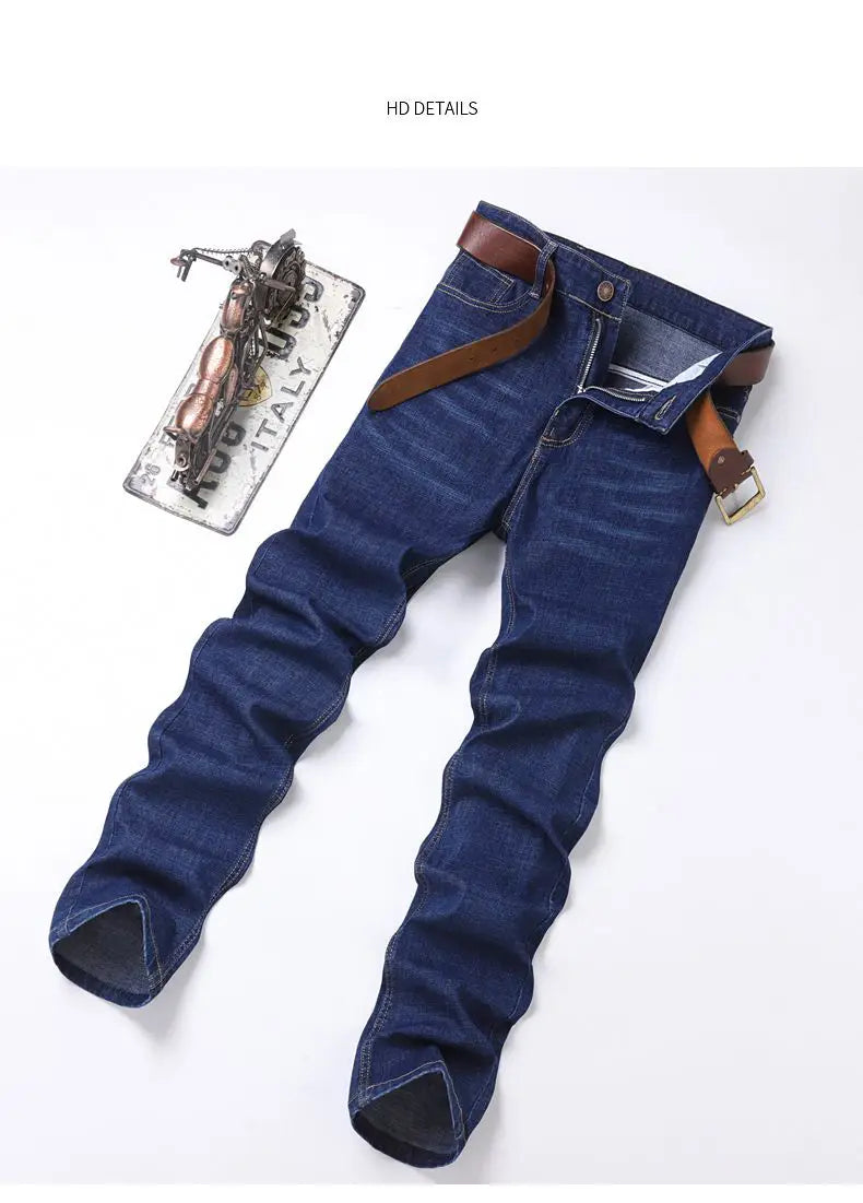 Men’s stretch cotton straight jeans in dark blue denim with a brown leather belt threaded through the loops for casual wear.