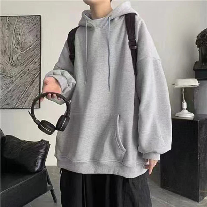Hoodie en polaire grise ample avec cordons et poche avant, conçu comme un pullover décontracté pour un port confortable