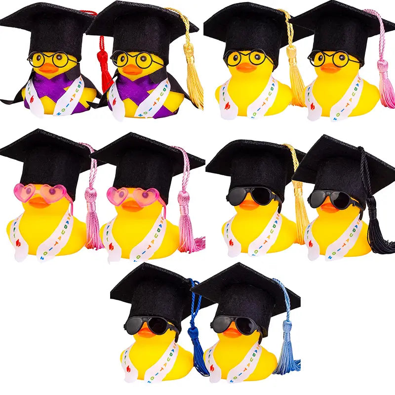 yellow rubber duck graduation car dashboard ornament with black mortarboard caps, colorful tassels, and printed sashes