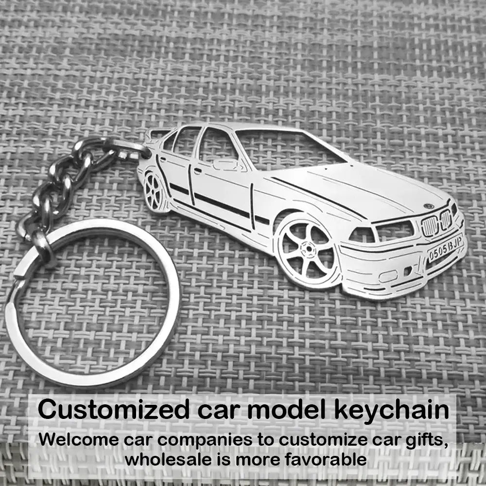 Silver metallic customized car model metal keychain shaped like a BMW E36 sedan with detailed wheels and grille.