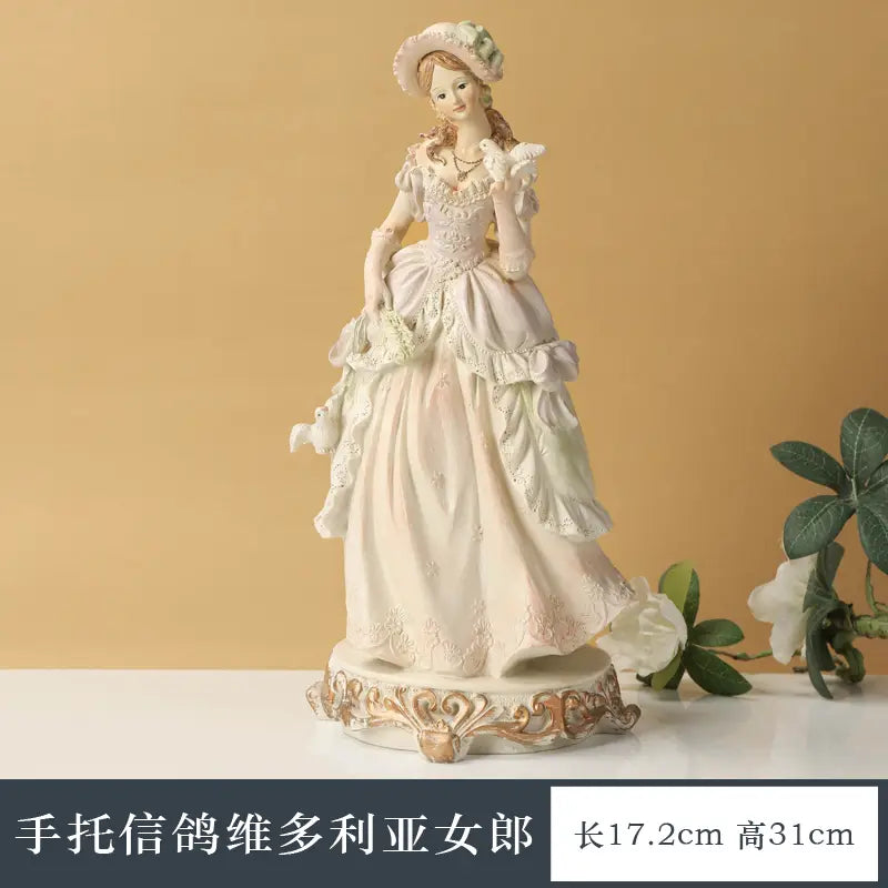 Elegant porcelain victorian couple resin figurine featuring a lady in an off-white lace gown holding a white dove for home decor.