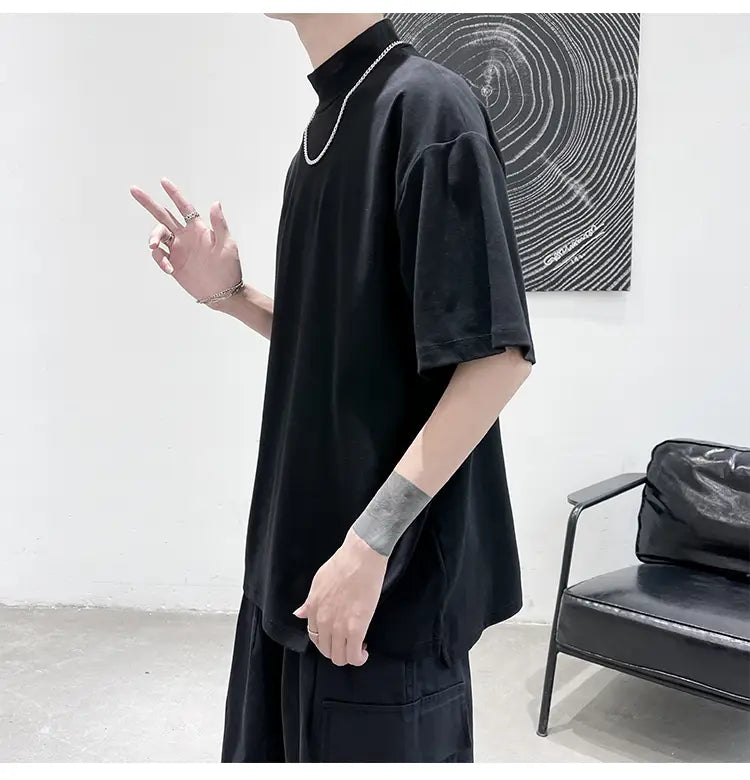 Black short-sleeved oversized turtleneck t-shirt with a relaxed fit designed for casual streetwear.