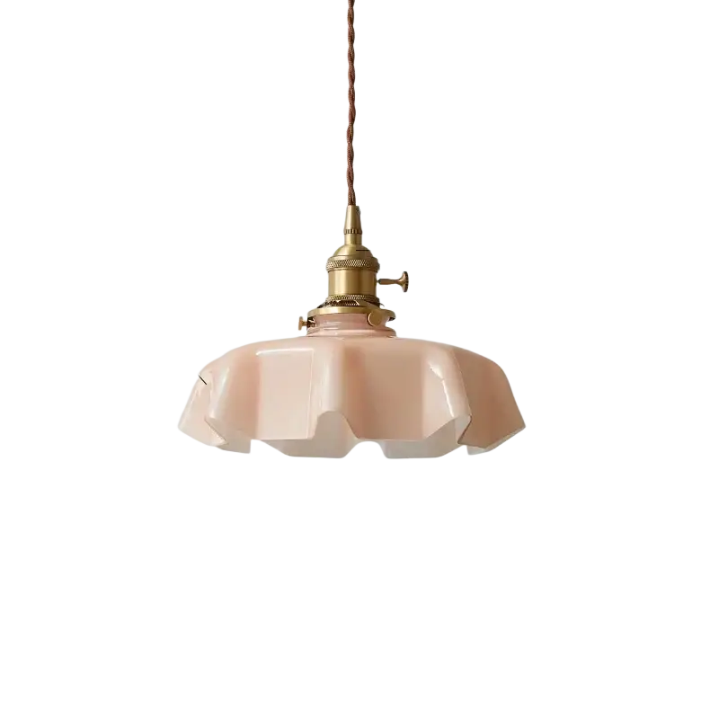 Light pink glass pendant lamp with brass hardware and braided cord shown from front angle for dining room use