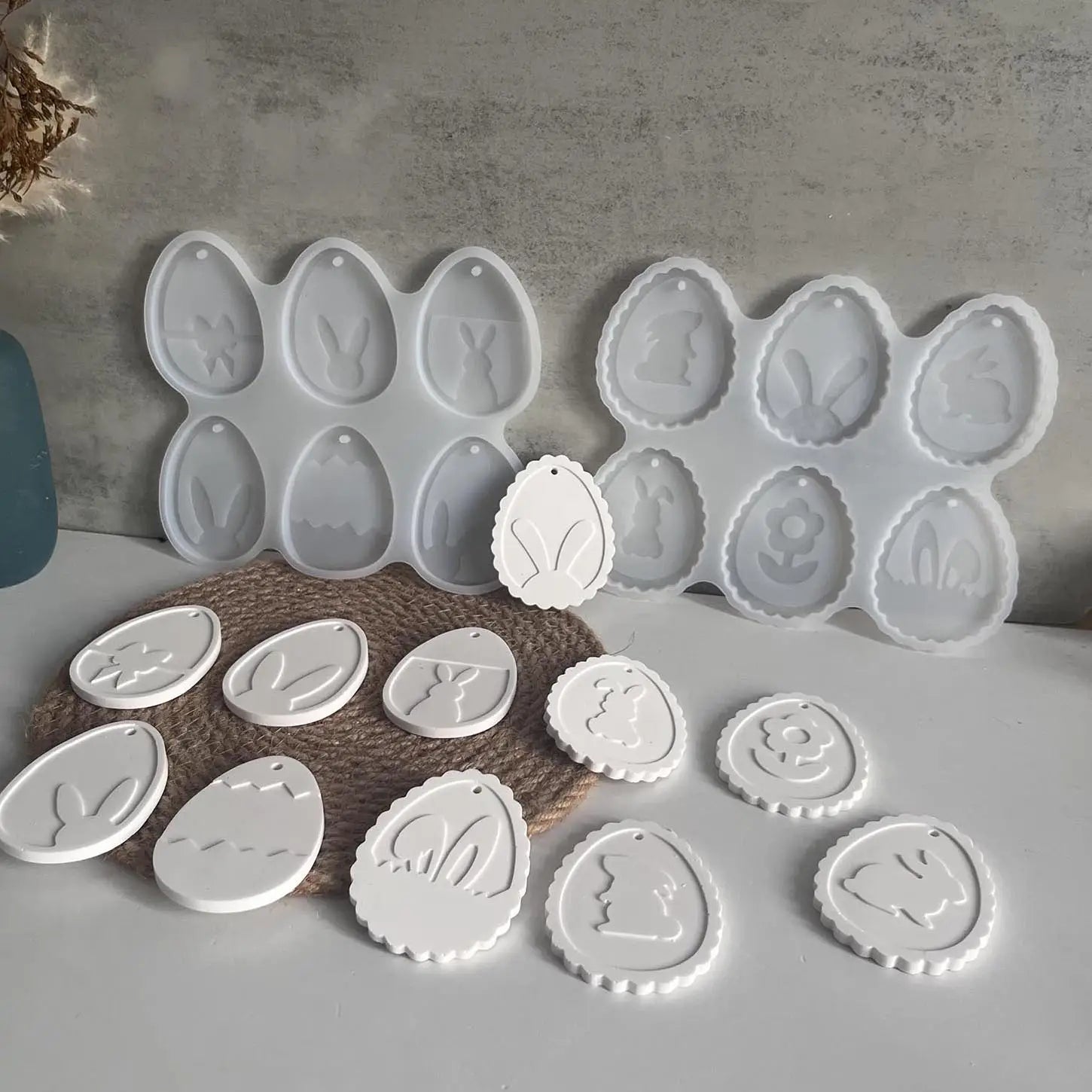 white silicone easter bunny silicone resin pendant mold with floral designs and finished white resin ornaments displayed.