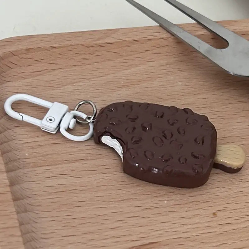 Chocolate biscuit cartoon key chain bag pendant featuring a chocolate-covered ice cream bar design with a white plastic carabiner and wooden stick.