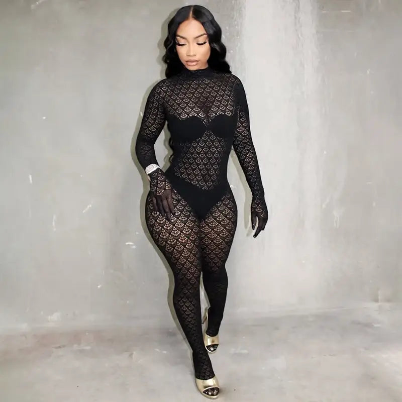 Black lace fishnet see through long romper with high neckline and long sleeves featuring an intricate diamond patterned mesh design.