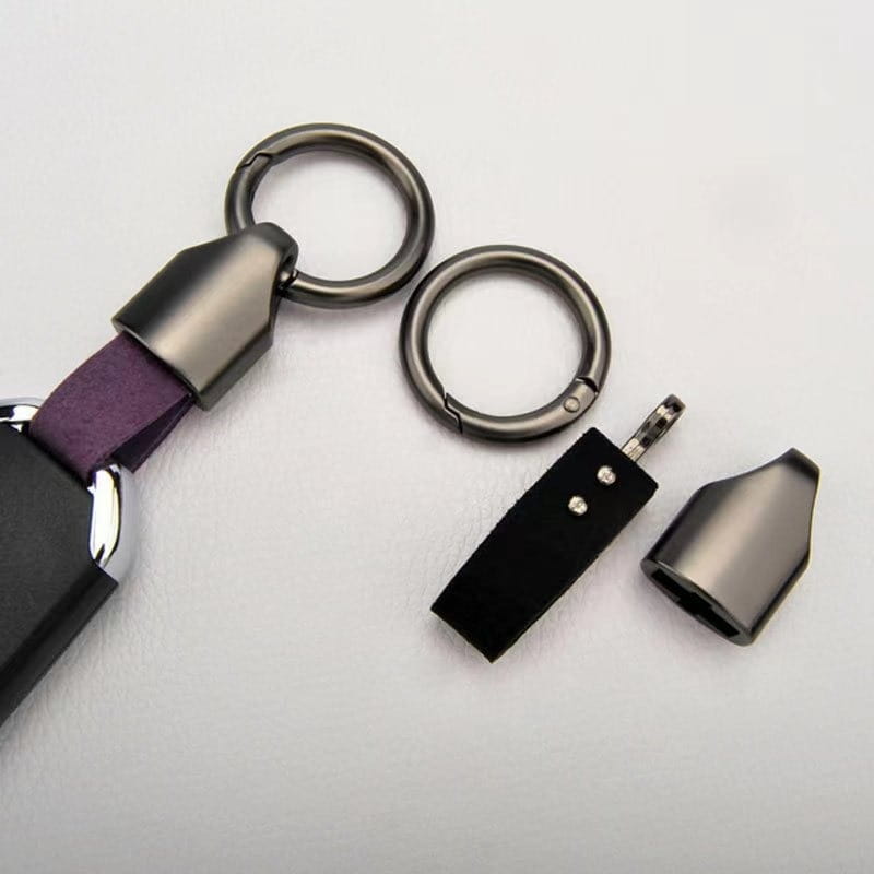 Purple leather car keychain with a matte black metal connector and two circular key rings for secure key organization.