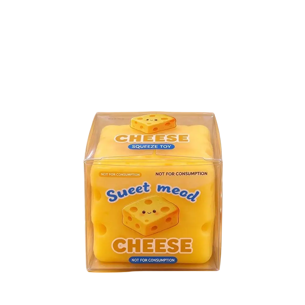 Front view of yellow cheese-shaped slow rising stress relief squeeze toy in clear packaging with cartoon face and sweet mead text