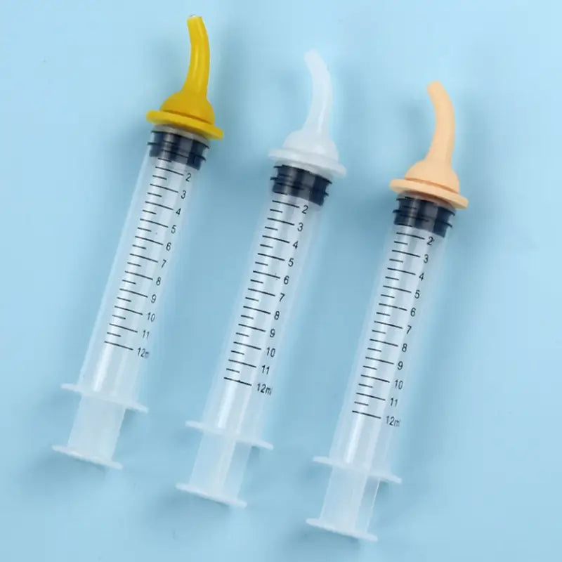 three transparent plastic pet oral syringes with silicone nipple feeders and yellow white and beige caps designed for accurate pet medication administration