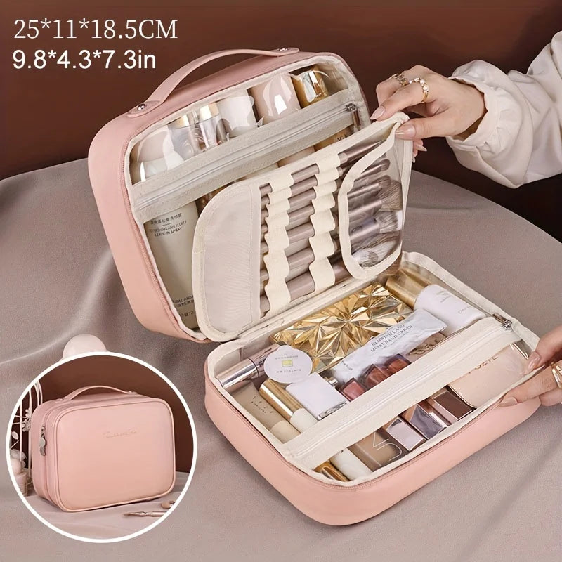 Pink leather makeup organizer with multiple compartments and a top handle designed as a double layer travel makeup bag in beige pu leather.